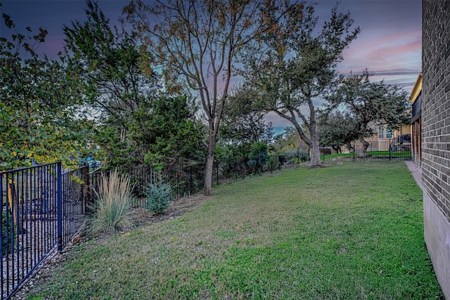 view of yard at dusk