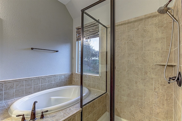 bathroom with separate shower and tub and lofted ceiling