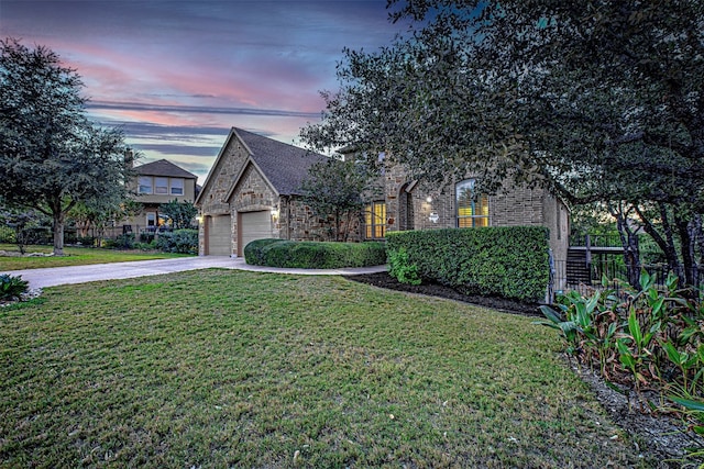 view of front facade featuring a garage and a lawn