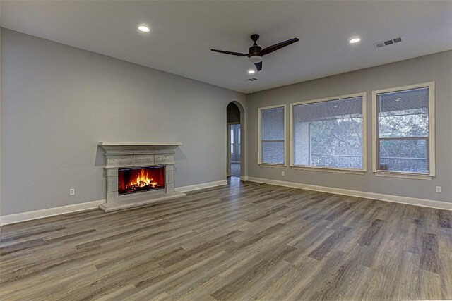 unfurnished living room featuring hardwood / wood-style floors and ceiling fan