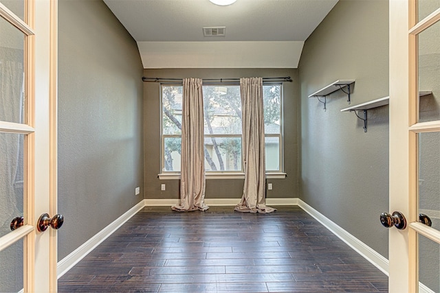 spare room with french doors, dark hardwood / wood-style floors, and lofted ceiling