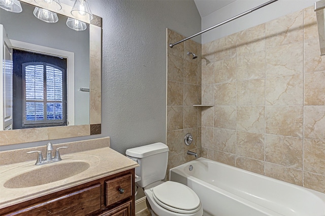 full bathroom with vanity, toilet, and tiled shower / bath