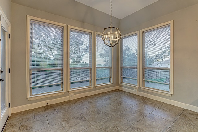 unfurnished dining area with light tile patterned floors and a notable chandelier