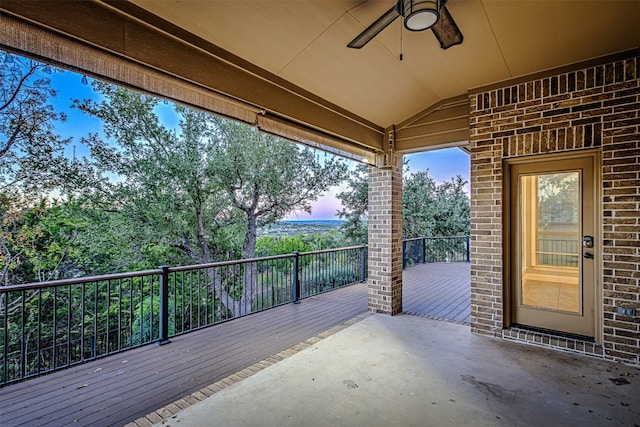 patio terrace at dusk with ceiling fan and a wooden deck