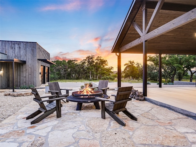 patio terrace at dusk featuring a fire pit