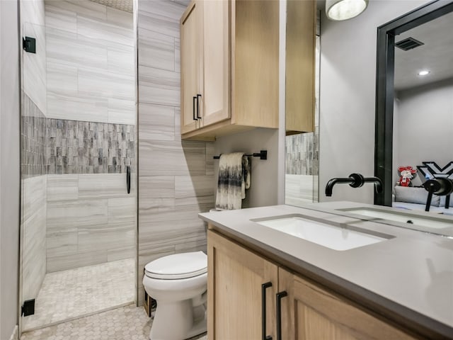 bathroom featuring walk in shower, tile patterned flooring, vanity, and toilet