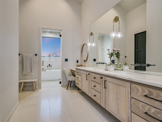 bathroom featuring tile patterned flooring, vanity, and a tub