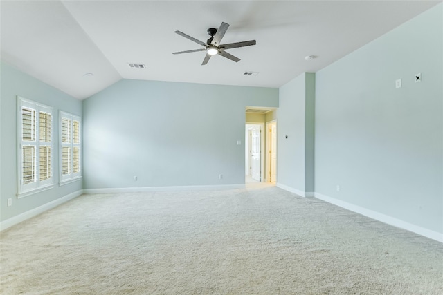 carpeted spare room featuring ceiling fan and vaulted ceiling