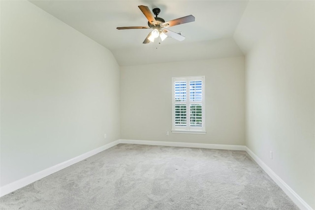 unfurnished room featuring carpet, ceiling fan, baseboards, and lofted ceiling