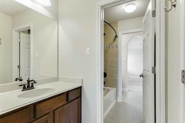 bathroom featuring vanity, tile patterned floors, and tiled shower / bath combo