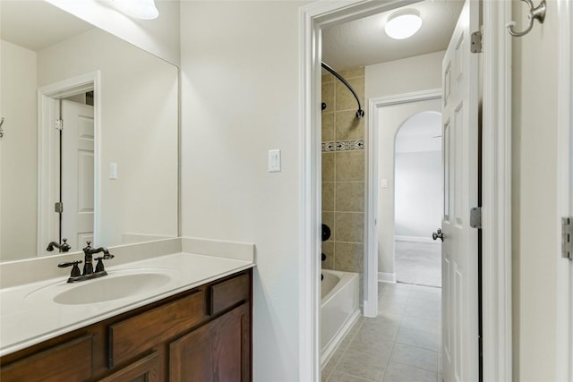 bathroom featuring tile patterned flooring, bathing tub / shower combination, and vanity