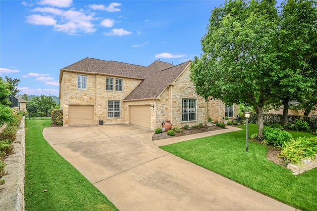 view of front of home with a front yard and a garage