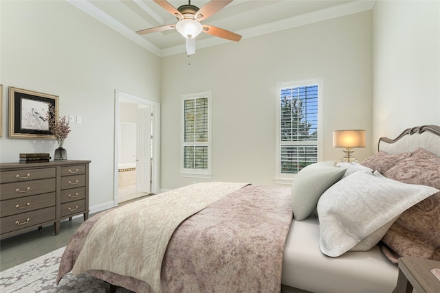 bedroom featuring ceiling fan, ornamental molding, and connected bathroom