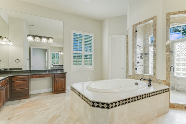 bathroom with plus walk in shower, vanity, and a healthy amount of sunlight