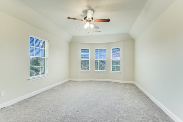 unfurnished room featuring carpet floors, plenty of natural light, lofted ceiling, and ceiling fan