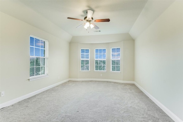 empty room featuring healthy amount of natural light, carpet floors, and a ceiling fan