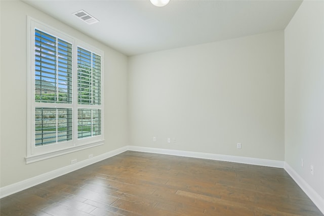 spare room with dark wood-type flooring