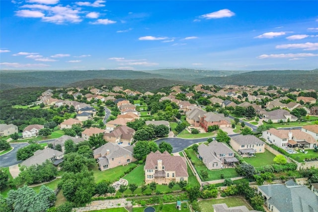 aerial overview of property's location with nearby suburban area and a mountainous background