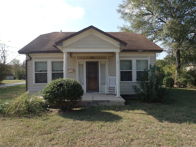 bungalow-style house featuring a front yard