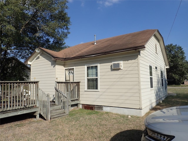 rear view of property with a wooden deck and a lawn