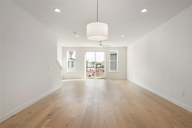 unfurnished living room with light hardwood / wood-style flooring and ceiling fan