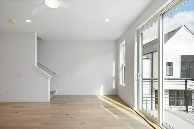 spare room featuring ceiling fan and light wood-type flooring