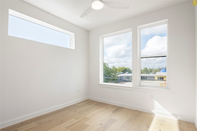 spare room featuring light hardwood / wood-style flooring and ceiling fan