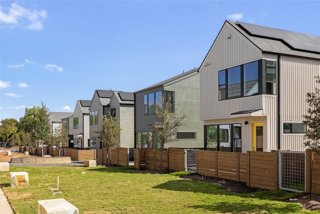 exterior space featuring a lawn and solar panels