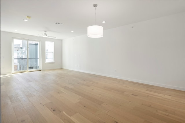 spare room featuring light hardwood / wood-style flooring and ceiling fan