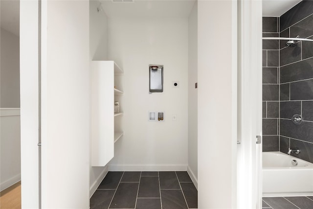 bathroom featuring tile patterned flooring and tiled shower / bath