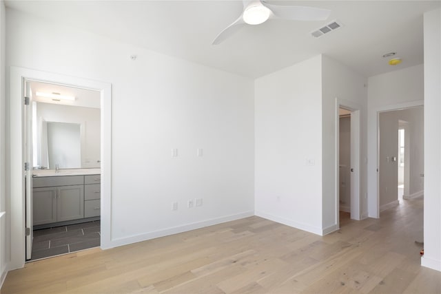 unfurnished room with ceiling fan and light hardwood / wood-style floors