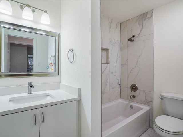 full bathroom with tiled shower / bath combo, toilet, and vanity