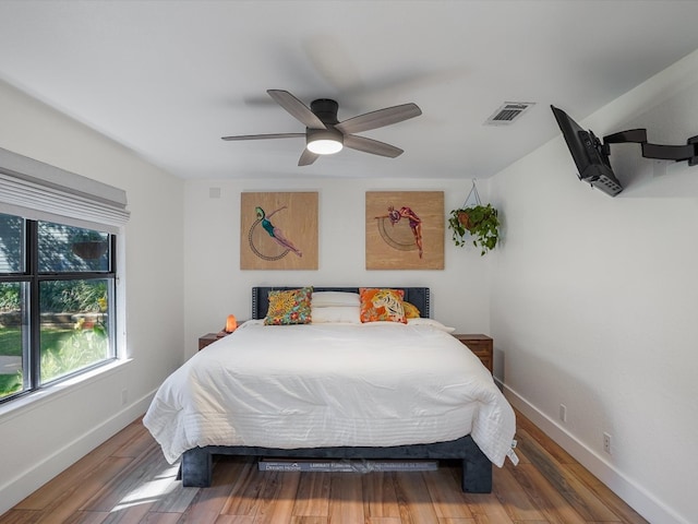 bedroom with hardwood / wood-style flooring and ceiling fan