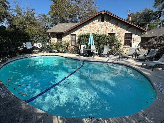 view of swimming pool featuring a patio area