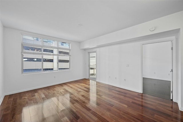 spare room featuring wood-type flooring