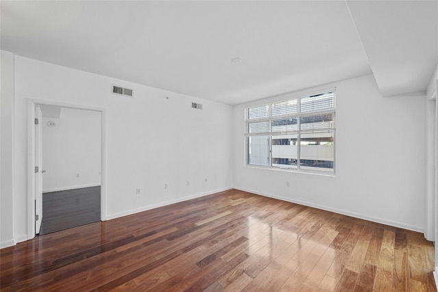 spare room featuring dark hardwood / wood-style flooring