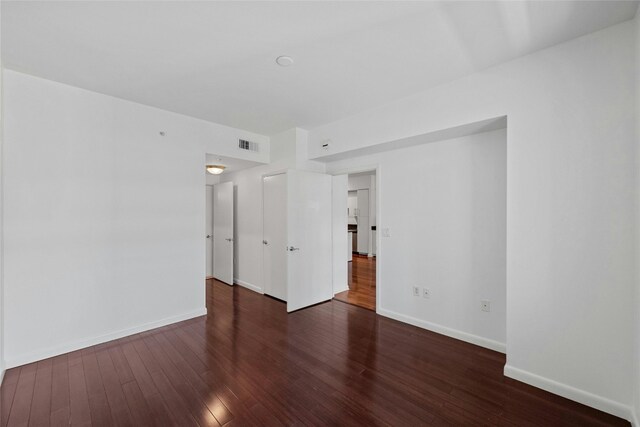 empty room with dark hardwood / wood-style floors