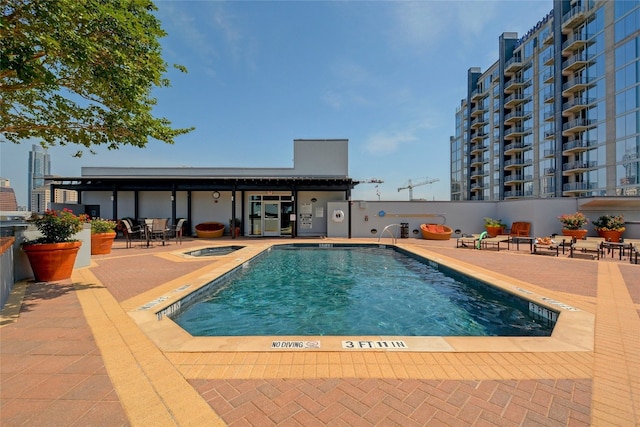 view of pool with a patio area and a community hot tub