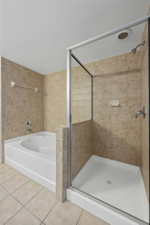 bathroom featuring tile patterned flooring and independent shower and bath