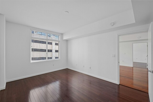 spare room featuring dark hardwood / wood-style floors