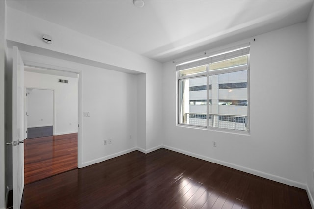 54 Rainey St Unit 613, Austin, TX 78701 - empty room featuring dark wood-style flooring and baseboards