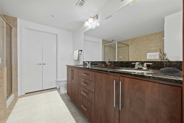 54 Rainey St Unit 613, Austin, TX 78701 - full bathroom with a stall shower, double vanity, toilet, and tile patterned floors