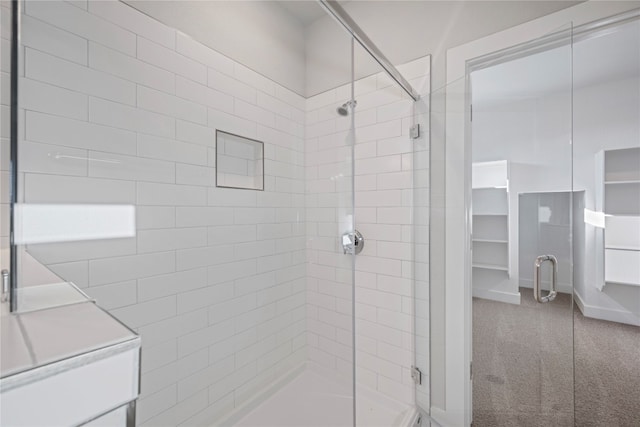 bathroom with a shower with door