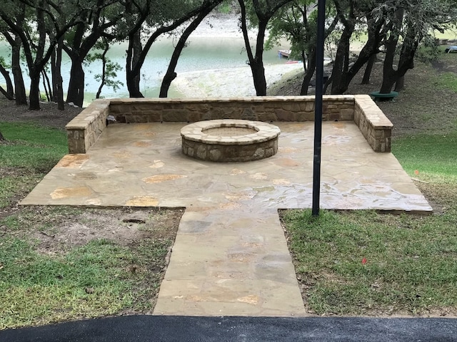 view of patio / terrace featuring a fire pit and a water view