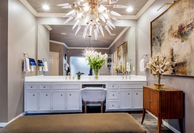 bathroom featuring vanity, ornamental molding, and a notable chandelier