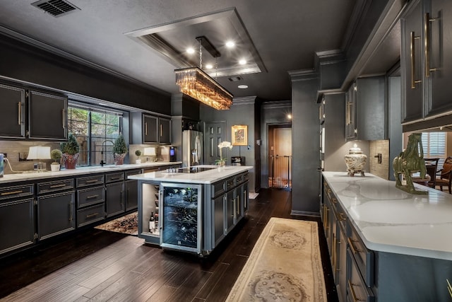 kitchen featuring dark wood-type flooring, stainless steel refrigerator with ice dispenser, wine cooler, decorative backsplash, and an island with sink