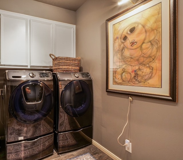 washroom featuring hardwood / wood-style floors, cabinets, and separate washer and dryer