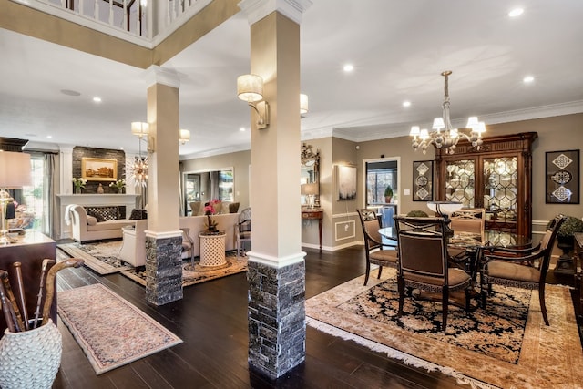 dining space with decorative columns, a wealth of natural light, dark hardwood / wood-style floors, and ornamental molding