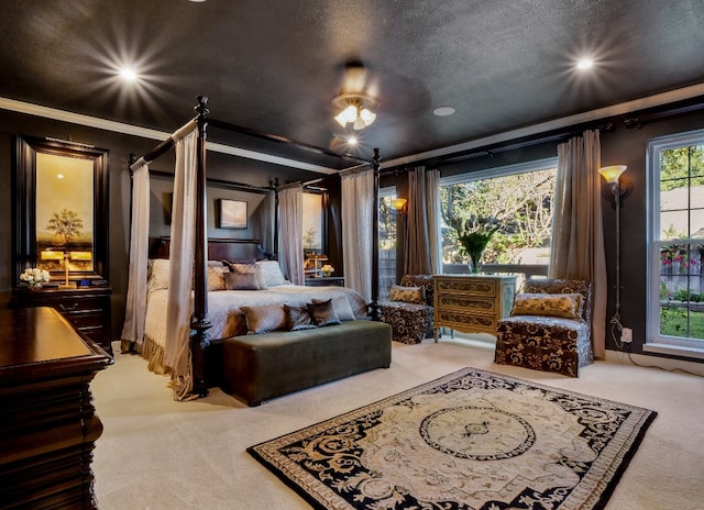 bedroom featuring carpet, a textured ceiling, ceiling fan, and ornamental molding