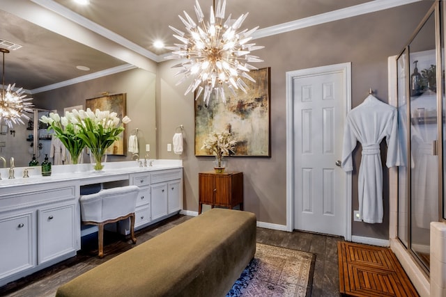 bathroom featuring hardwood / wood-style flooring, vanity, ornamental molding, and a notable chandelier